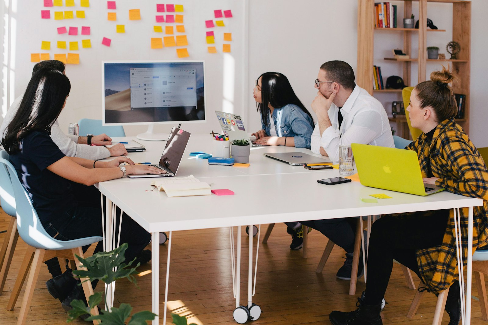 A travel advisor greeting a new client across a desk, symbolizing agency growth and winning bookings without buying leads
