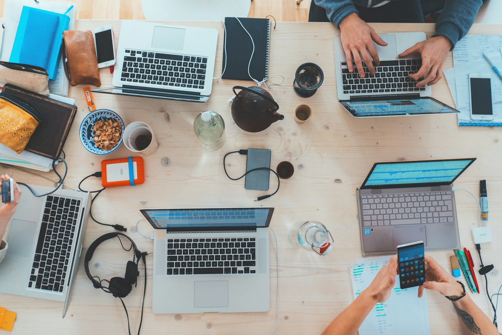 A team collaborating around laptops, representing modern travel agency operations